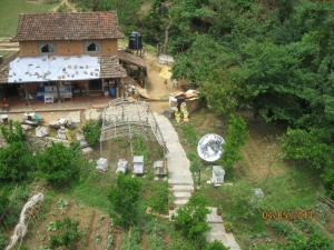 View of the farm house, solar cooker, orange tress, and bees